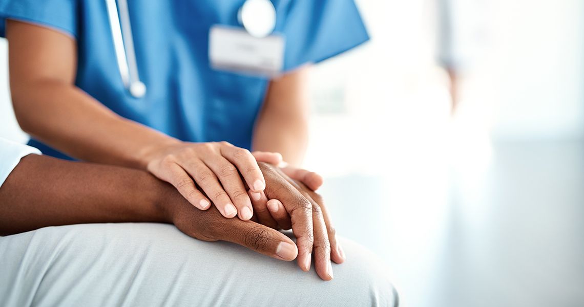 Doctor holding patient's hand